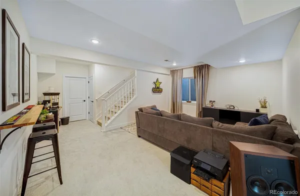 a living room with furniture and a piano