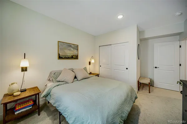 a bedroom with a bed and a lamp