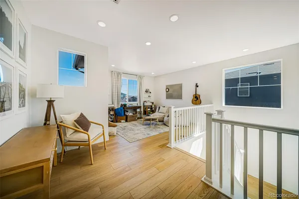a living room with furniture a flat screen tv and next to a window