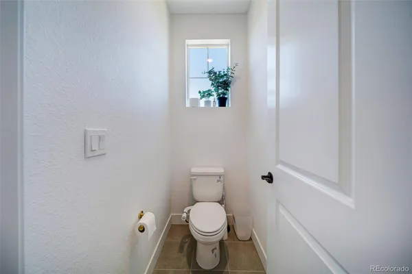 a white toilet sitting next to a white cabinet