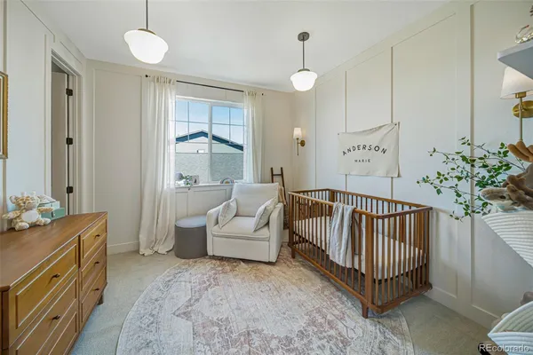 a spacious bedroom with a bed and a chandelier