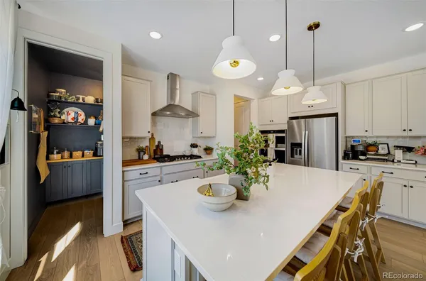 a kitchen with a dining table and chairs