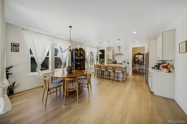 a dining room with furniture and wooden floor