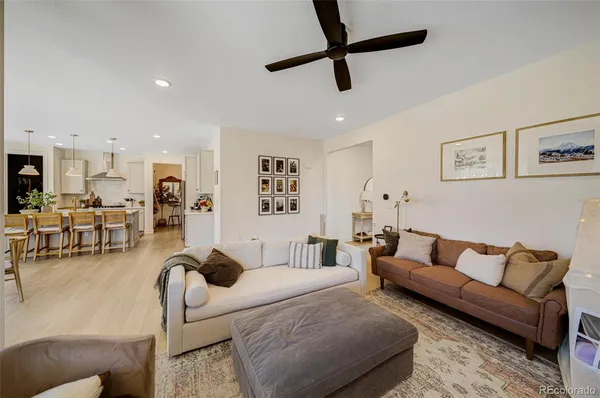 a living room with furniture and a view of kitchen