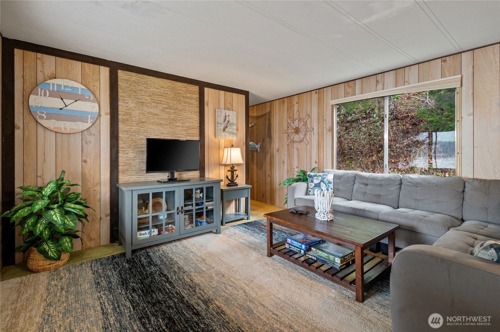 71 Bald Point Court Tahuya, WA 98588 - Photo 3 of 32 a living room with furniture a flat screen tv and a large window