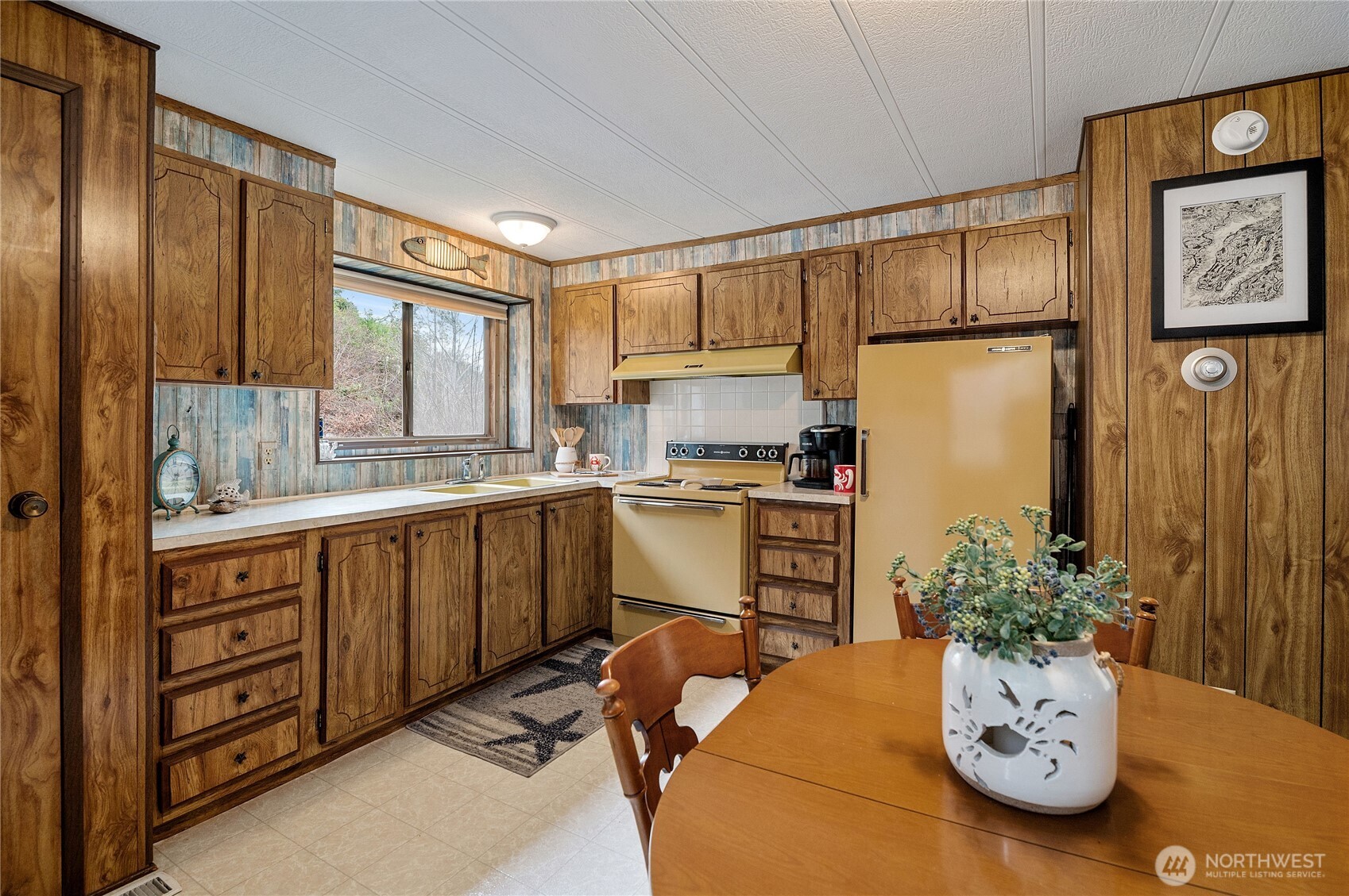 71 Bald Point Court Tahuya, WA 98588 - Photo 9 of 32 a kitchen with stainless steel appliances kitchen island granite countertop a refrigerator a stove and a wooden floors