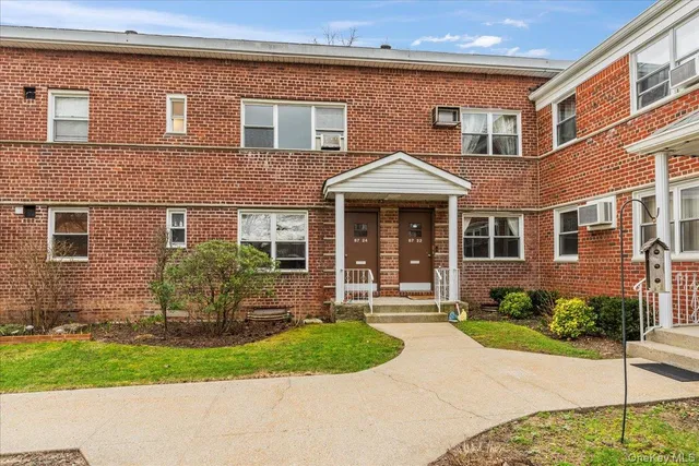 a front view of a house with a yard and outdoor seating