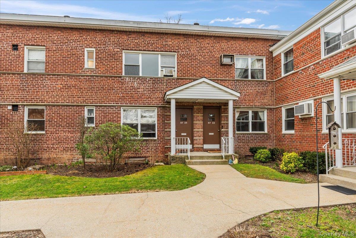 a front view of a house with a yard and outdoor seating
