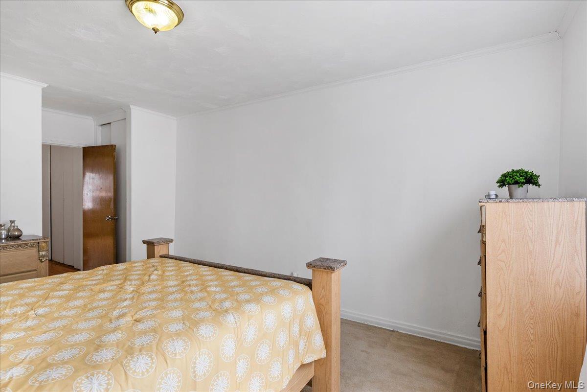 87-24 Marengo Street, Unit 2B Queens, NY 11423 - Photo 17 of 22 a bedroom with a bed and a window