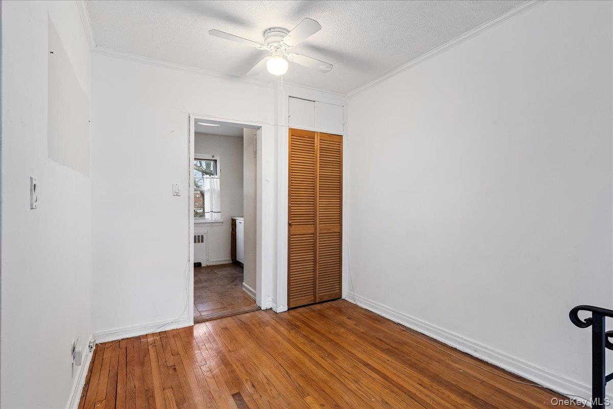 87-24 Marengo Street, Unit 2B Queens, NY 11423 - Photo 3 of 22 a view of a big room with closet and a ceiling fan