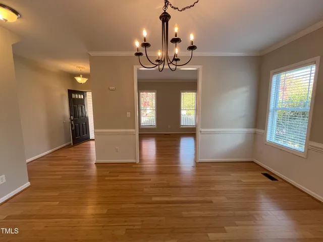 a view of a room with kitchen wooden floor and windows