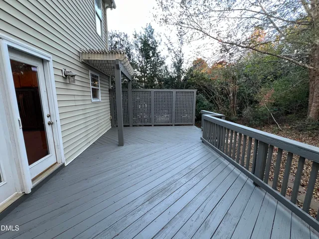 a view of a house with wooden deck