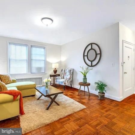 a living room with furniture a window and a table