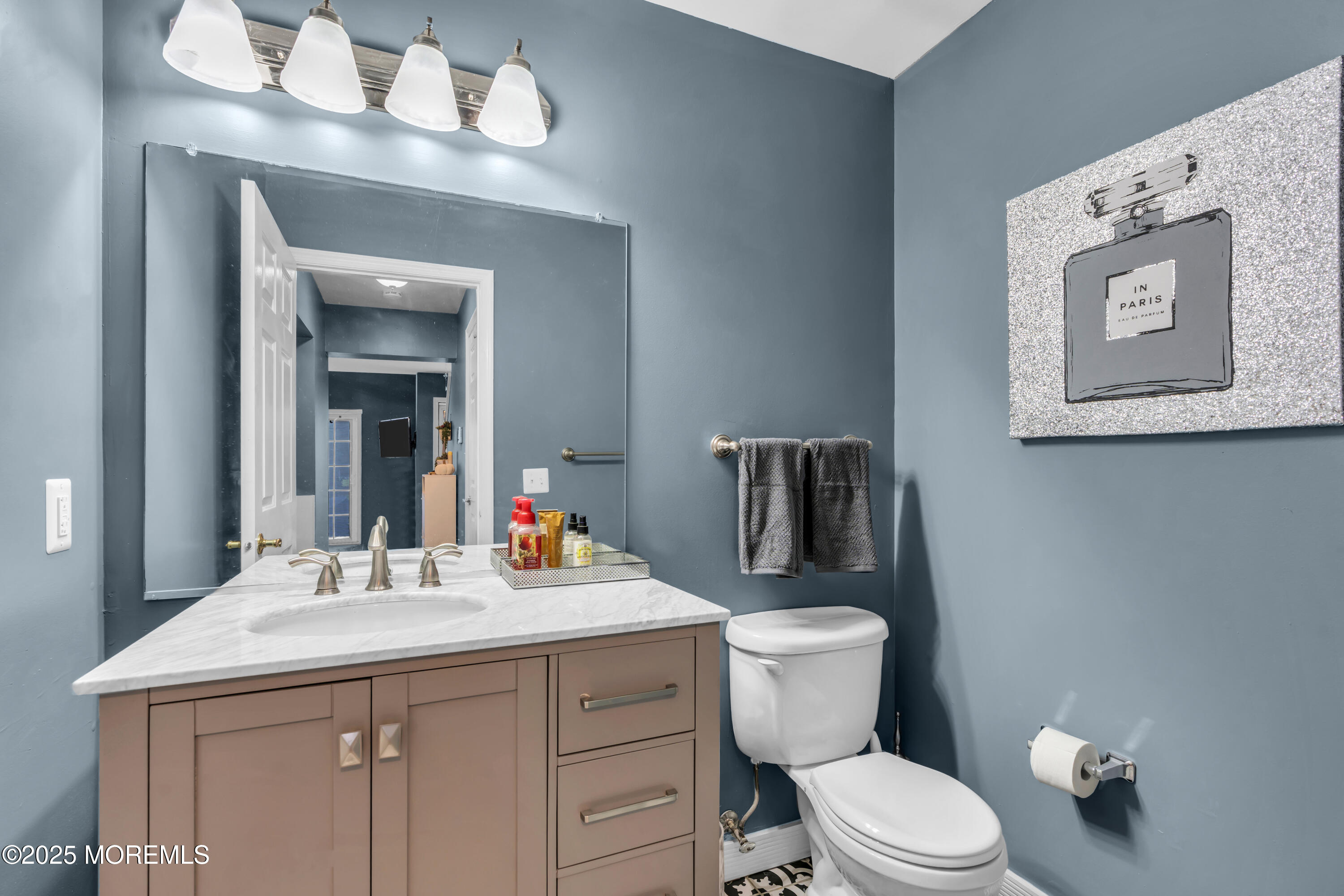 11 Madison Court Tinton Falls, NJ 07712 - Photo 12 of 24 a bathroom with a toilet a sink and mirror