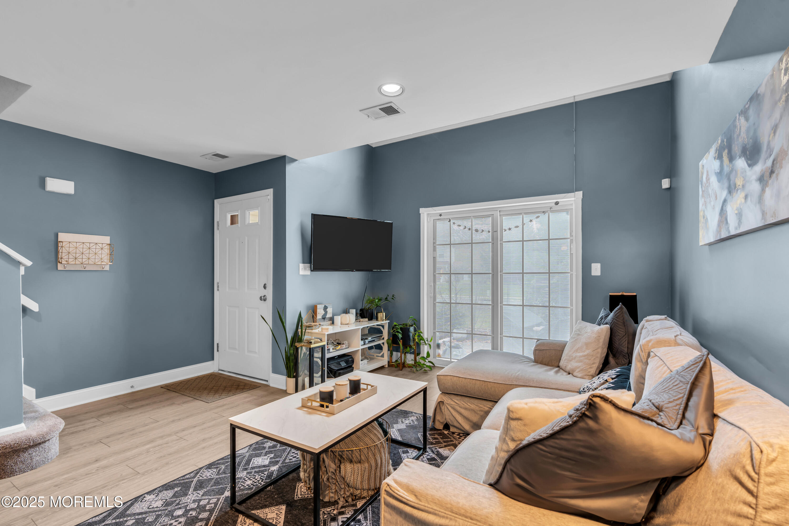 11 Madison Court Tinton Falls, NJ 07712 - Photo 6 of 24 a living room with furniture and a flat screen tv