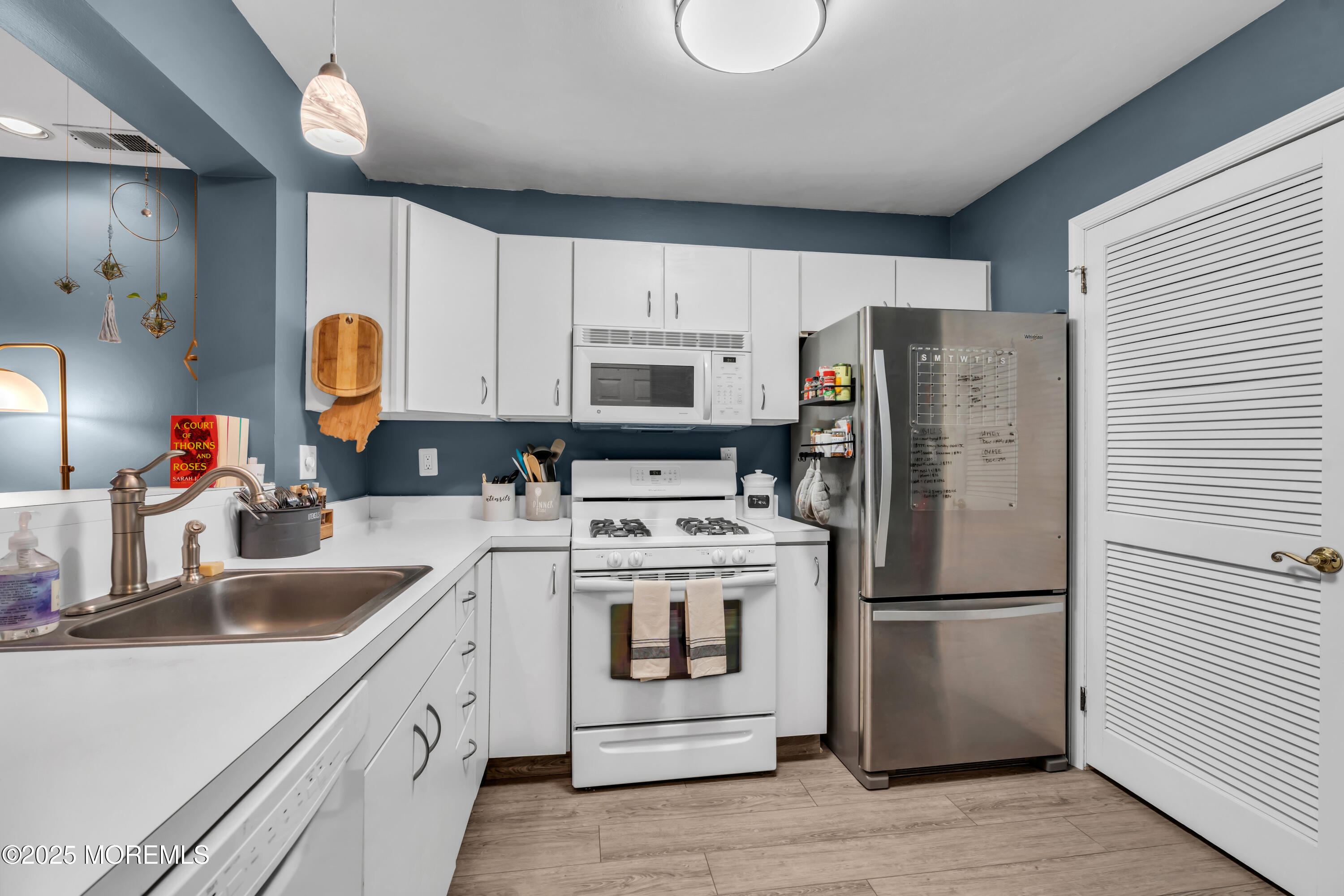 11 Madison Court Tinton Falls, NJ 07712 - Photo 9 of 24 a kitchen with a refrigerator sink and cabinets