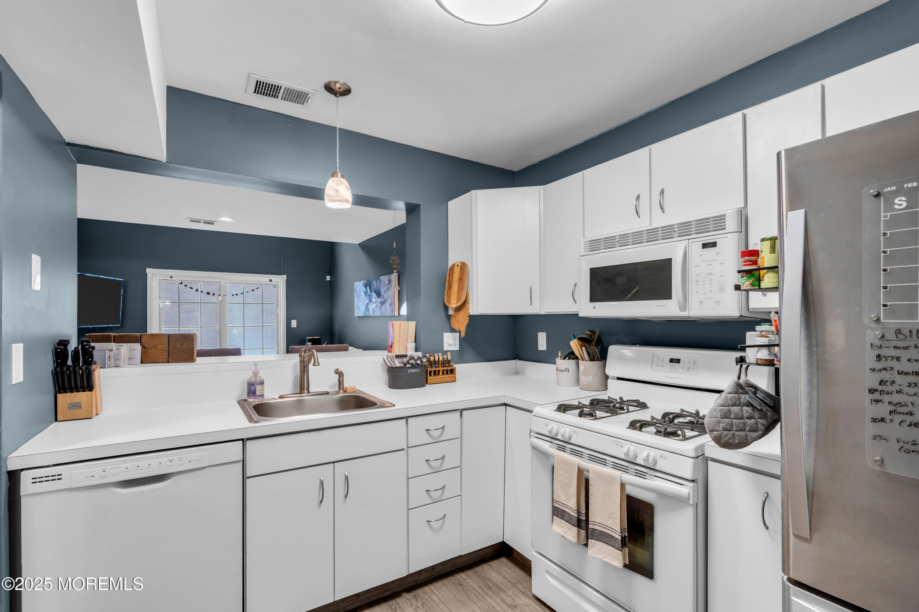 11 Madison Court Tinton Falls, NJ 07712 - Photo 10 of 24 a kitchen with white cabinets and white appliances