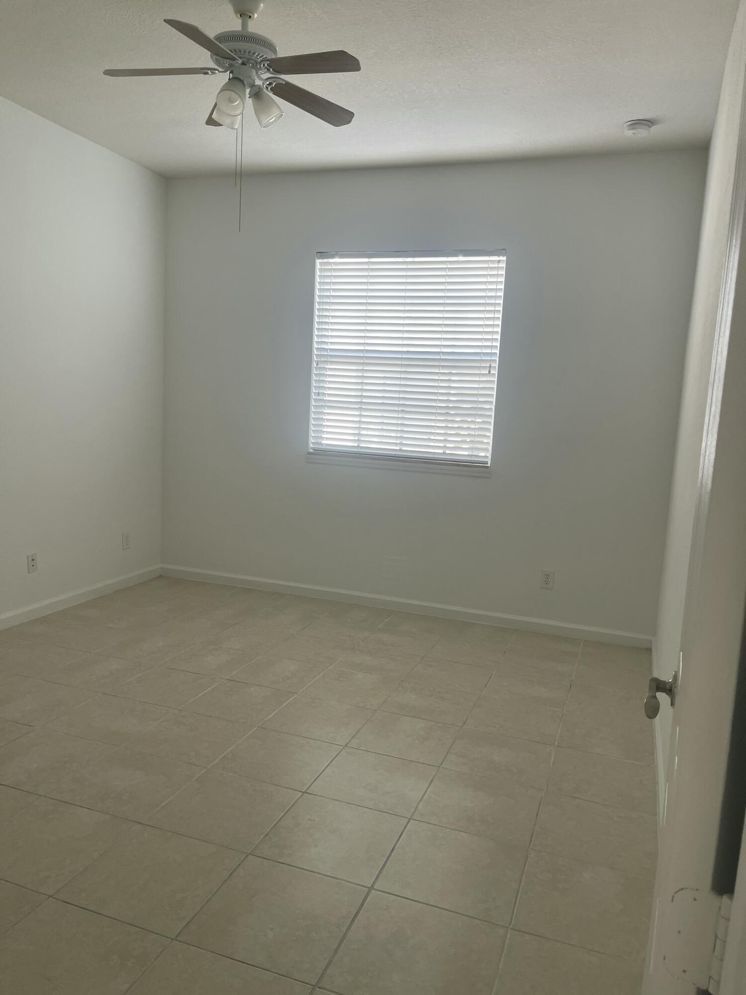 10440 Southwest Stephanie Way, Unit 211 Port St. Lucie, FL 34987 - Photo 5 of 13 an empty room with a window
