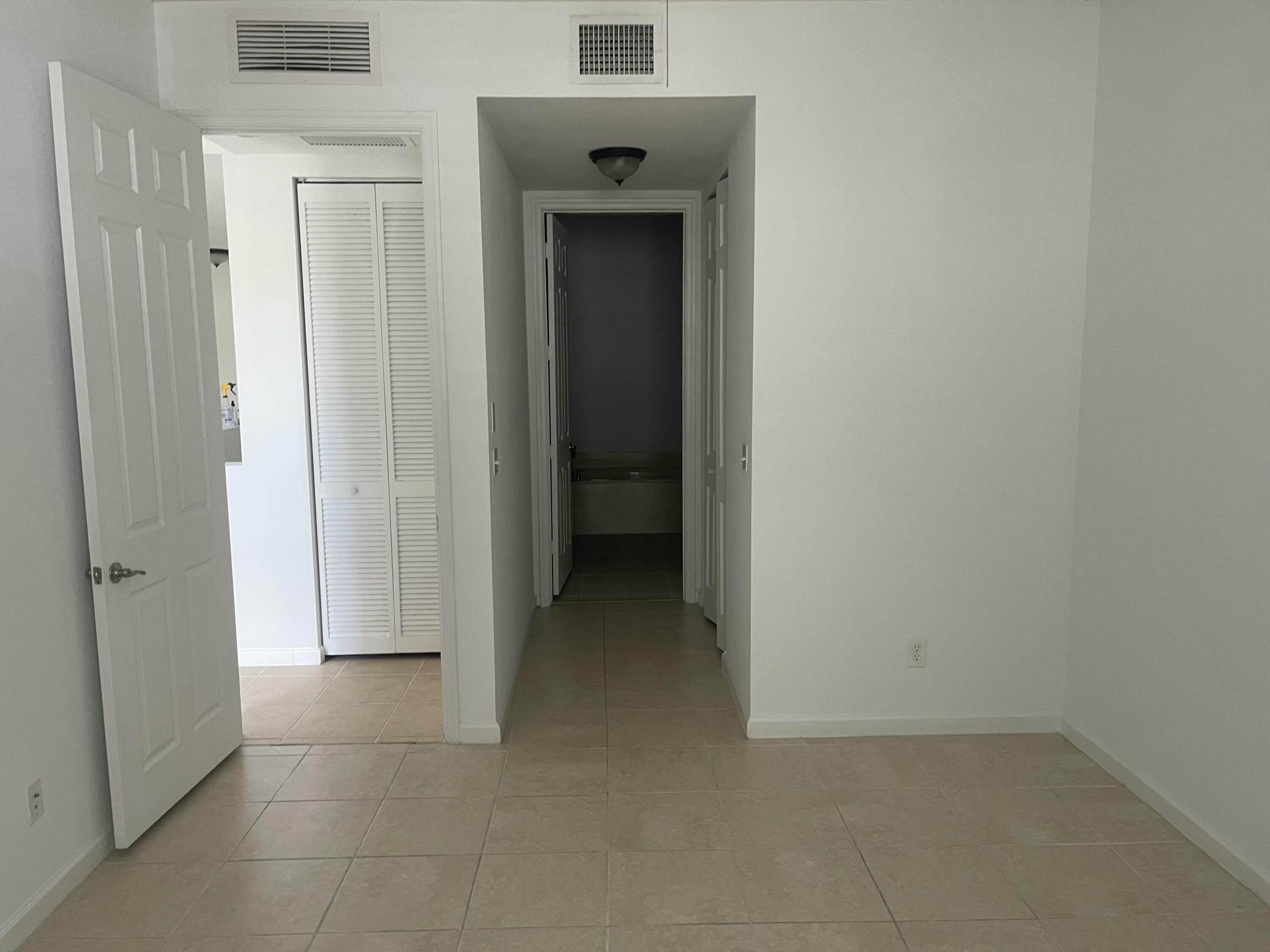10440 Southwest Stephanie Way, Unit 211 Port St. Lucie, FL 34987 - Photo 6 of 13 a view of a hallway with a hallway