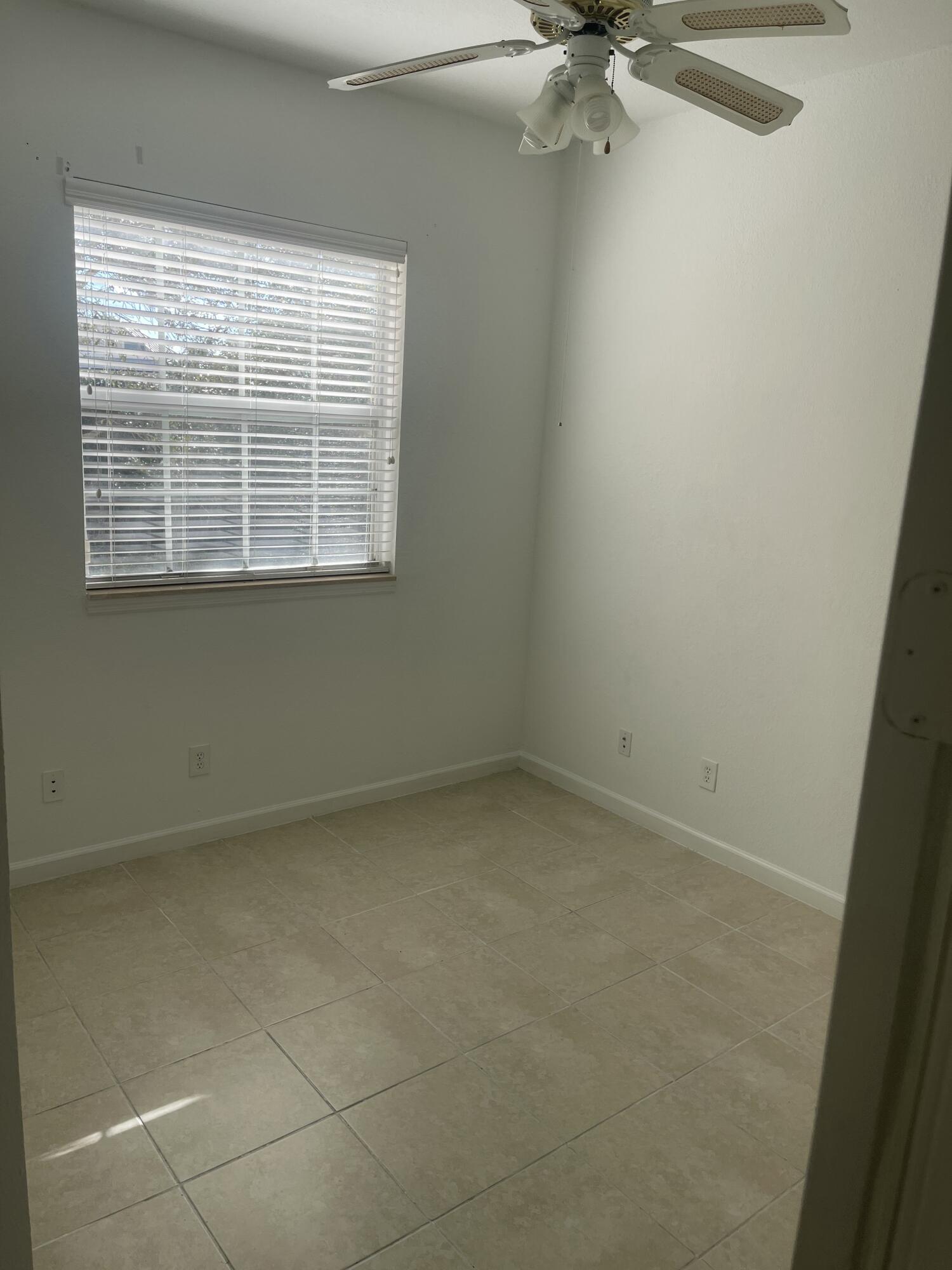 10440 Southwest Stephanie Way, Unit 211 Port St. Lucie, FL 34987 - Photo 8 of 13 an empty room with a window