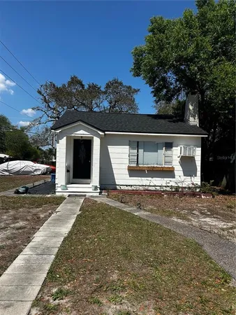 a view of a house with a yard and a garage