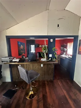 a view of a livingroom with furniture window wooden floor and front door