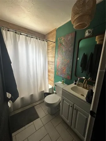 a bathroom with a double vanity sink toilet and a mirror