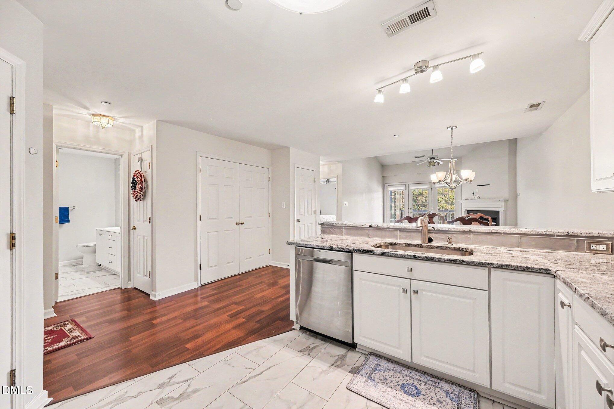 132 Springfork Drive Cary, NC 27513 - Photo 20 of 28 a spacious bathroom with a granite countertop sink a toilet a mirror and shower