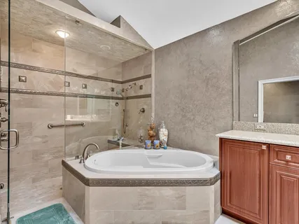 a spacious bathroom with a granite countertop sink mirror and double
