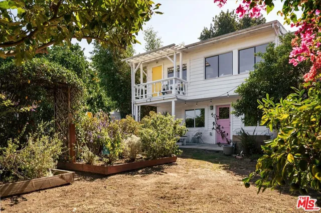 a view of a yard with wooden fence