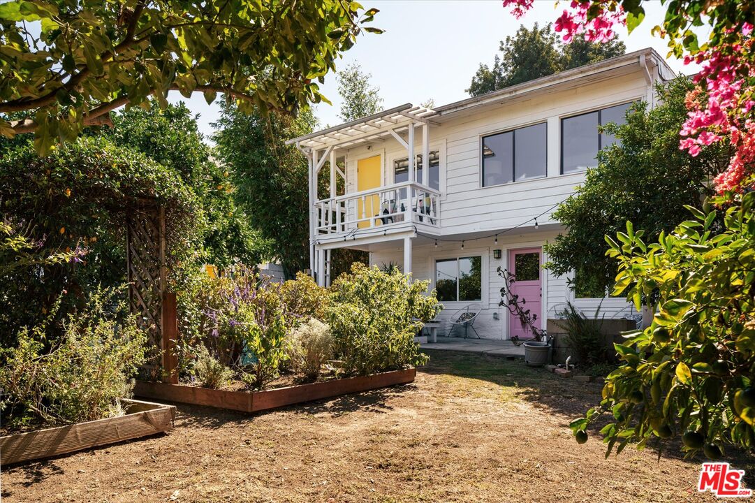 1741 Kent Street Los Angeles, CA 90026 - Photo 21 of 62 a front view of a house with a yard and potted plants