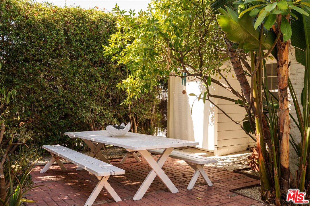1741 Kent Street Los Angeles, CA 90026 - Photo 61 of 62 a view of a patio with table and chairs with wooden fence and plants