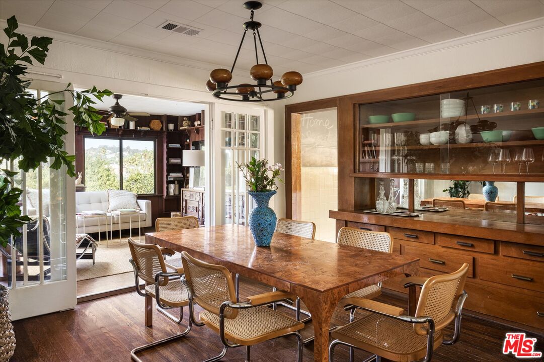 1741 Kent Street Los Angeles, CA 90026 - Photo 8 of 62 a dining room with wooden floor a chandelier a wooden table and chairs