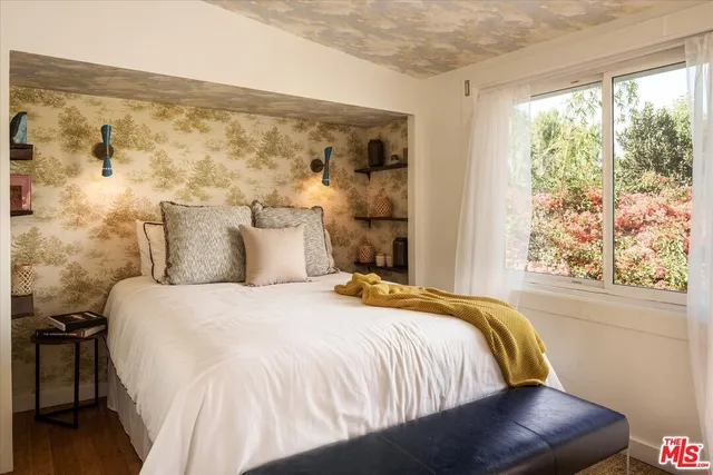 a bedroom with a bed and a chair