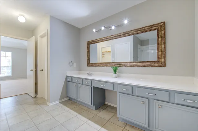 a bathroom with a shower and a glass door