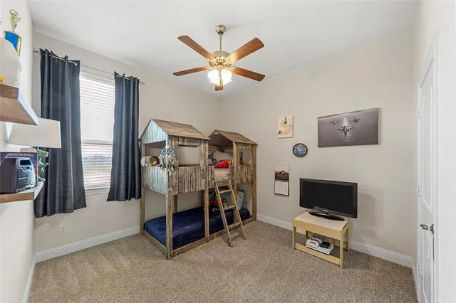 a bedroom with furniture and a ceiling fan