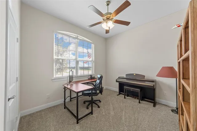 a view of a workspace with furniture and a window