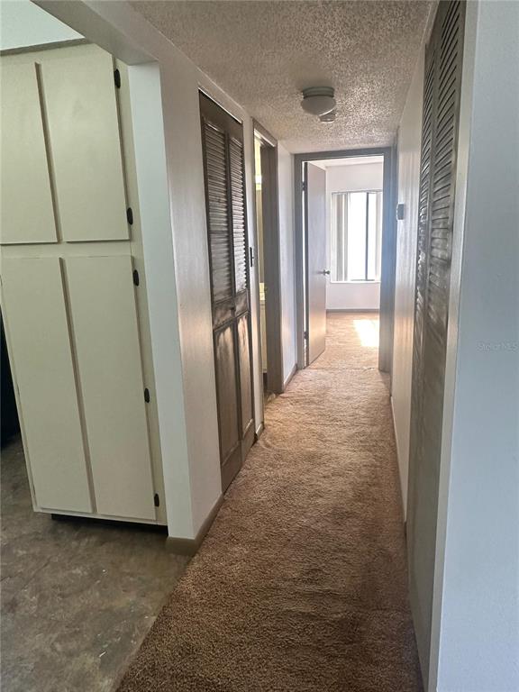 1235 South Pine Ridge Circle Sanford, FL 32773 - Photo 2 of 8 a view of a hallway with wooden floor and cabinets