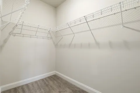 an empty room with closet and a bathroom