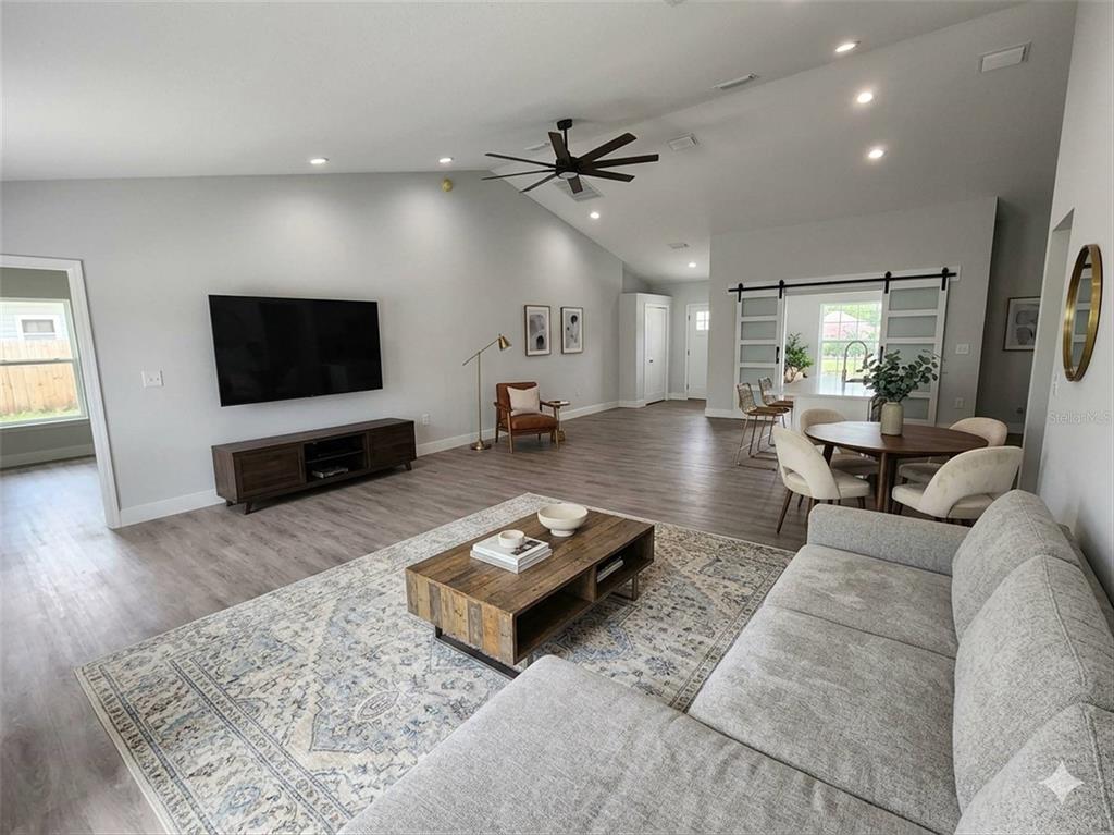 1111 Dagmar Avenue Spring Hill, FL 34606 - Photo 25 of 27 a living room with furniture and a flat screen tv