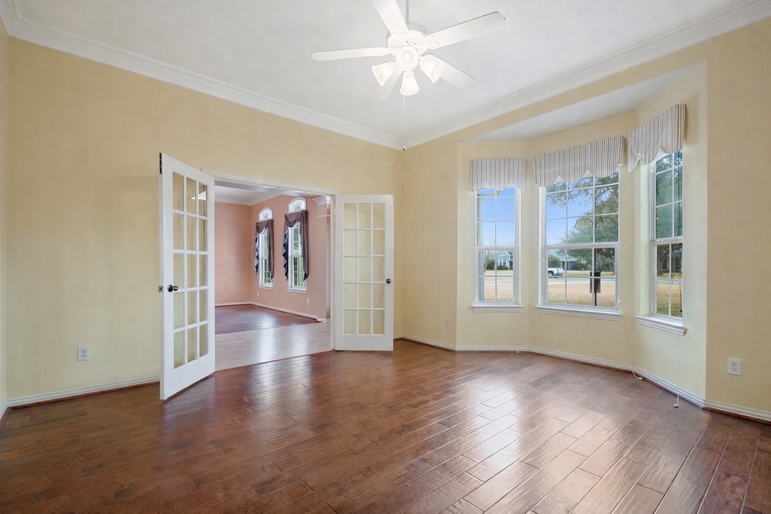31810 Tree Farm Lane Fulshear, TX 77441 - Photo 10 of 48 a view of an empty room with window and wooden floor