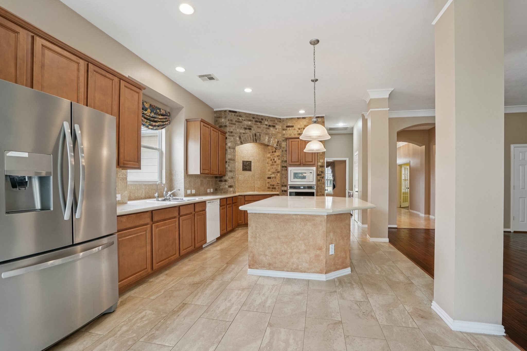 31810 Tree Farm Lane Fulshear, TX 77441 - Photo 11 of 48 a large kitchen with stainless steel appliances kitchen island granite countertop a refrigerator a oven a sink and a stove