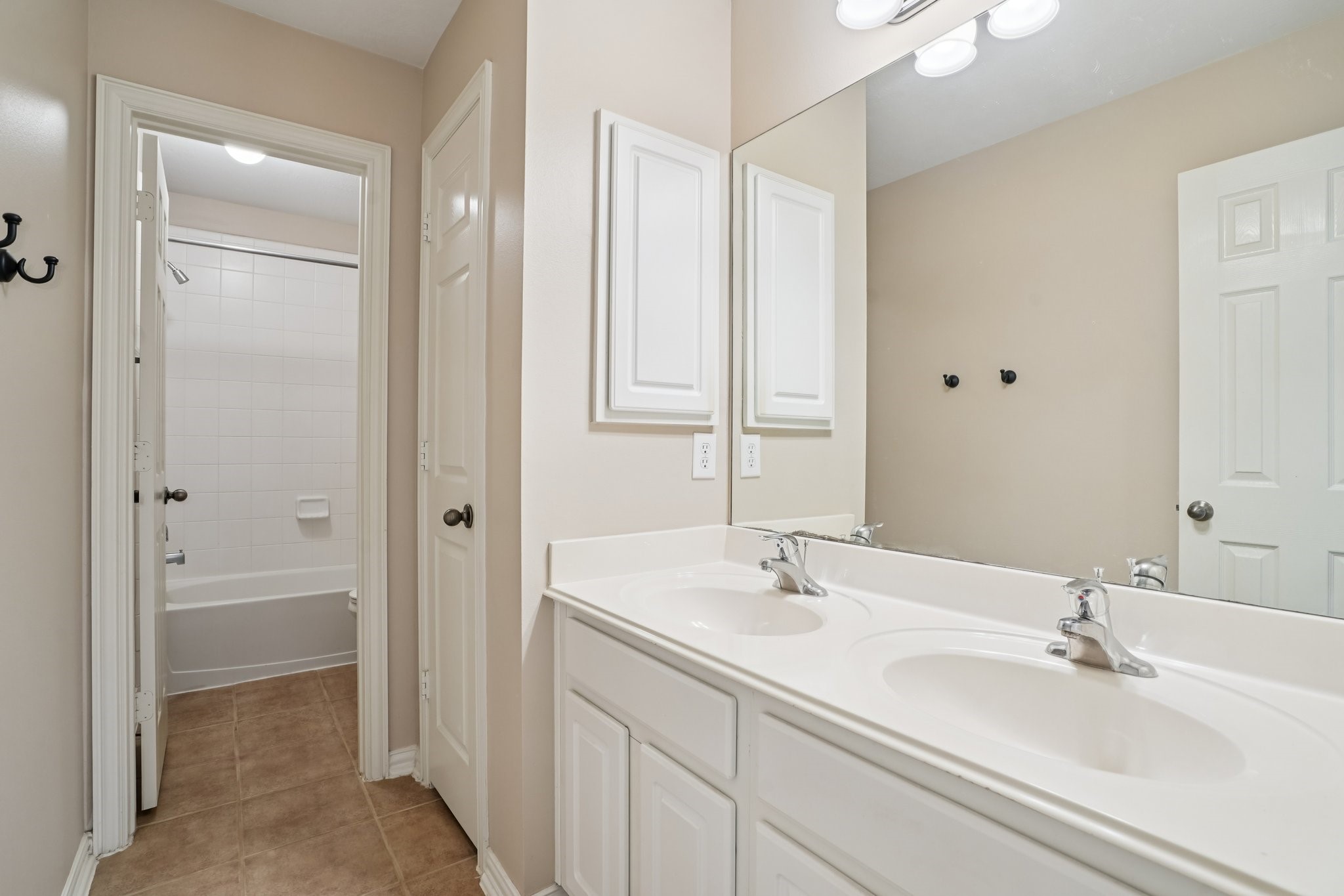 31810 Tree Farm Lane Fulshear, TX 77441 - Photo 25 of 48 a bathroom with 2 sink tub and a mirror