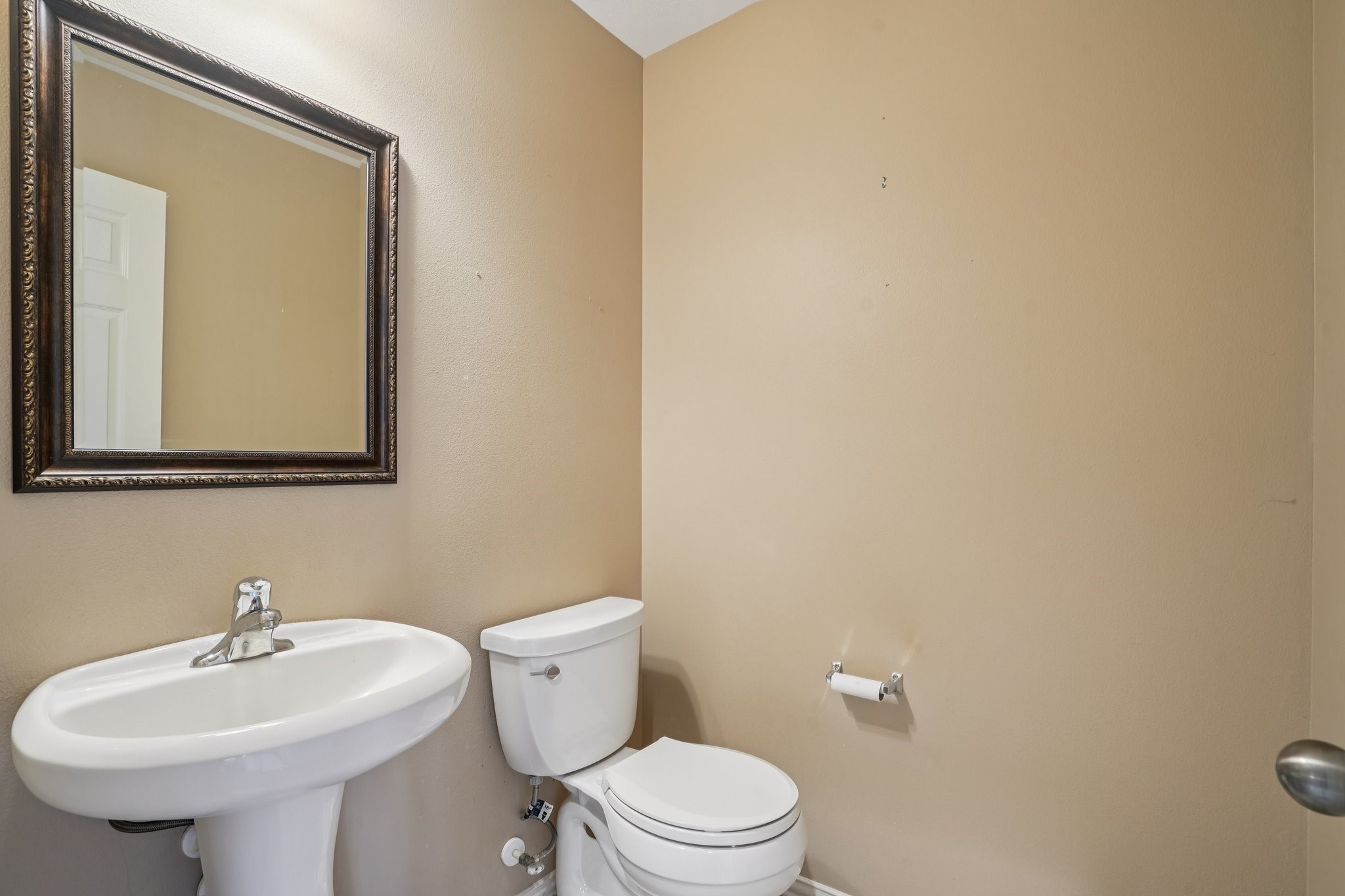 31810 Tree Farm Lane Fulshear, TX 77441 - Photo 28 of 48 a bathroom with a sink a mirror and a toilet