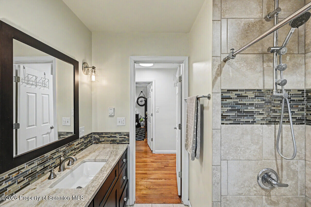 121 T Rt 351 Moscow, PA 18444 - Photo 54 of 79 a bathroom with a granite countertop sink a mirror and shower