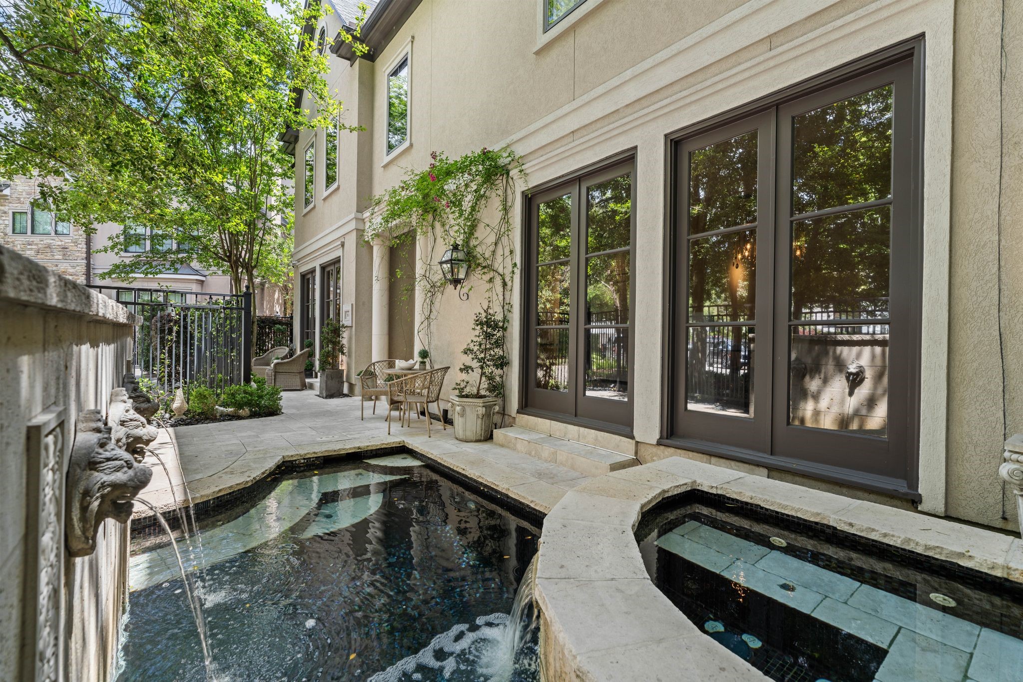 30 Hackberry Lane, Unit A Houston, TX 77027 - Photo 6 of 42 The cast-stone lionhead water feature behind the pool and spa creates a classic and tranquil atmosphere.