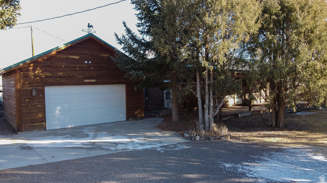 348 North Jakes Pl Road Loa, UT 84747 - Photo 6 of 26 View of front of property with concrete driveway and a garage