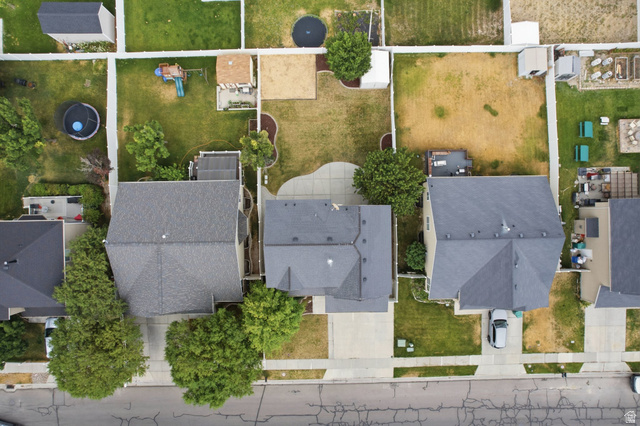 2223 North Pointe Meadow Loop Lehi, UT 84048 - Photo 49 of 56 Aerial view showcasing three residential properties with gray shingle roofs and concrete driveways