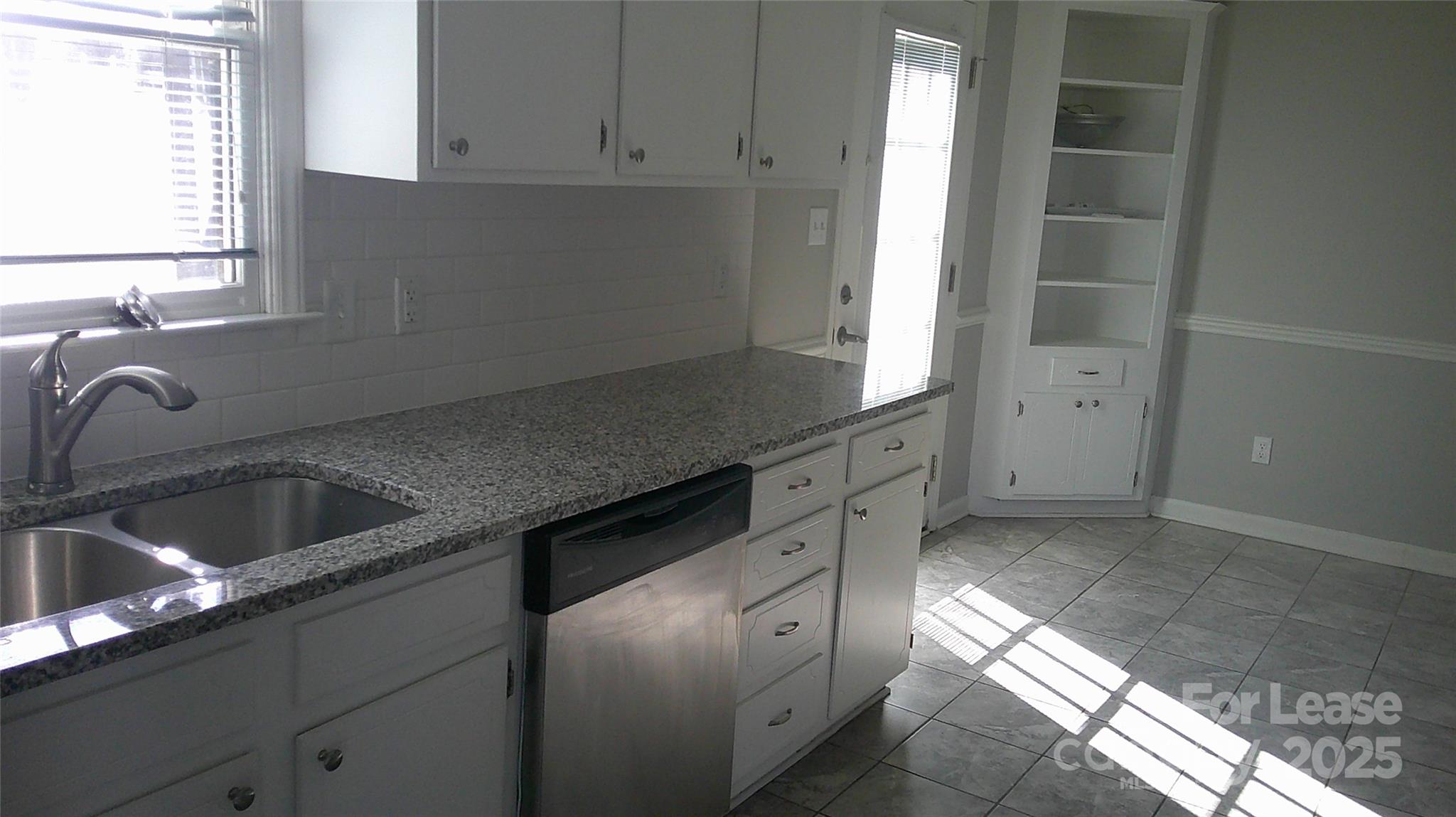 607 11th Street Southwest Hickory, NC 28602 - Photo 2 of 5 a kitchen with granite countertop a sink and a stove