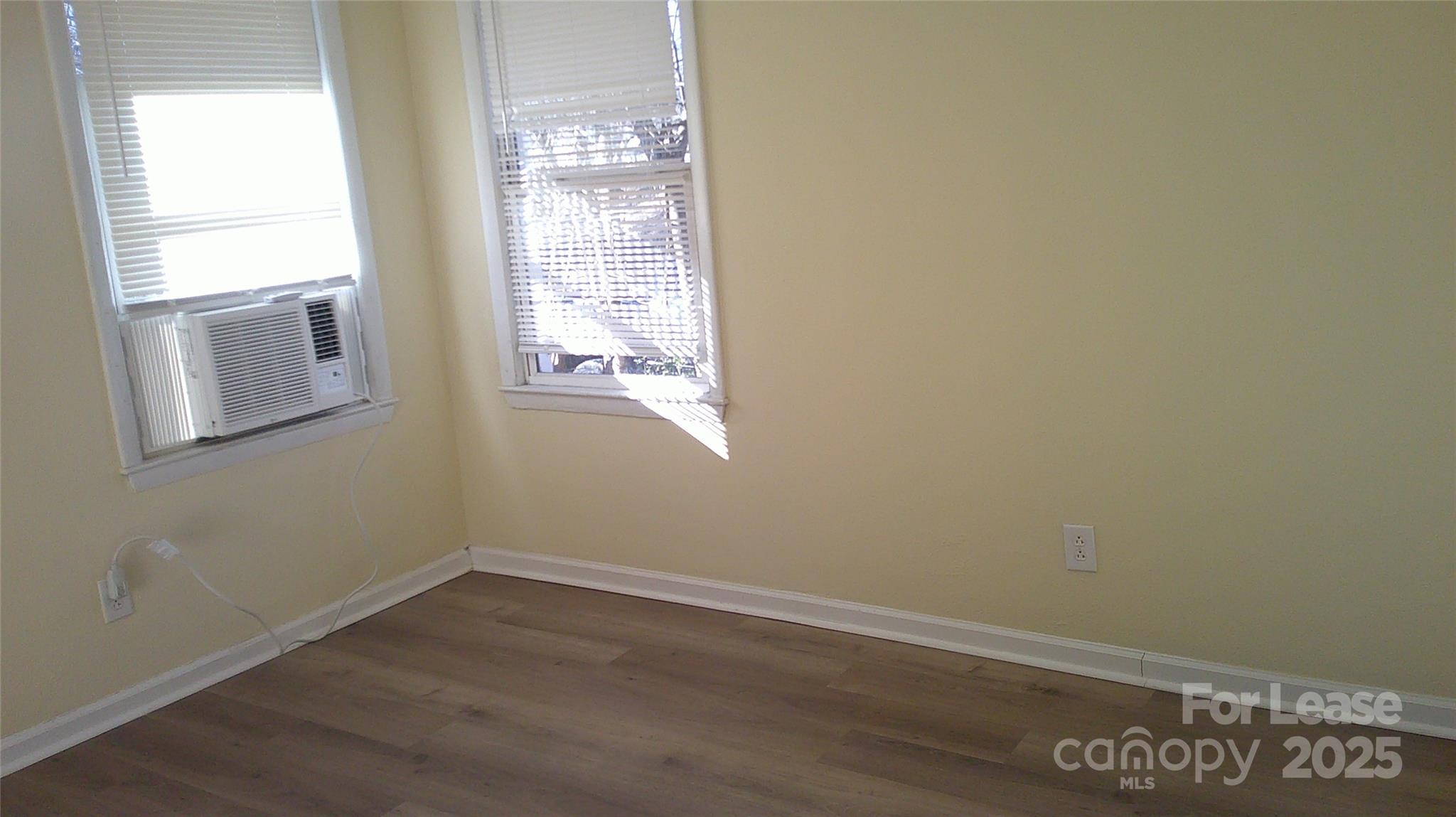 607 11th Street Southwest Hickory, NC 28602 - Photo 4 of 5 an empty room with wooden floor and windows